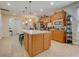Well-equipped kitchen with light wood cabinets, granite countertops, and an island at 541 Cantabria Dr, Davenport, FL 33837