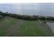 Aerial view of waterfront property with park, baseball field, and walking path at 659 Fortanini Cir, Ocoee, FL 34761
