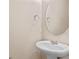Small bathroom with pedestal sink and oval mirror at 659 Fortanini Cir, Ocoee, FL 34761
