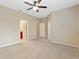 Spacious bedroom with ceiling fan and en-suite bathroom access at 659 Fortanini Cir, Ocoee, FL 34761