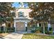 Tan two-story townhome with attached garage and landscaping at 659 Fortanini Cir, Ocoee, FL 34761