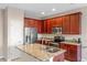Spacious kitchen featuring granite countertops and dark wood cabinets at 659 Fortanini Cir, Ocoee, FL 34761