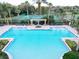 Relaxing community pool area with surrounding lounge chairs and tennis courts at 659 Fortanini Cir, Ocoee, FL 34761