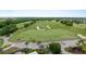 Aerial view of lush green golf course with golf carts at 7593 Gathering Dr # 802, Reunion, FL 34747