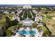 Aerial view showing community pool, clubhouse, and surrounding homes at 7593 Gathering Dr # 802, Reunion, FL 34747