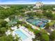 Aerial view of community amenities including pool, tennis, and playground at 7593 Gathering Dr # 802, Reunion, FL 34747