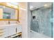 Modern bathroom with a walk-in shower, stylish vanity, and gold accents at 7593 Gathering Dr # 802, Reunion, FL 34747