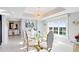 Elegant dining room with glass table and gold chairs at 7593 Gathering Dr # 802, Reunion, FL 34747