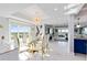 Elegant dining room with glass table, gold chairs, and stunning golf course views at 7593 Gathering Dr # 802, Reunion, FL 34747