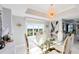 Bright dining room features a glass table, gold chairs, and large windows at 7593 Gathering Dr # 802, Reunion, FL 34747