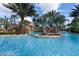 Relaxing lazy river with waterfall feature and lush landscaping at 7593 Gathering Dr # 802, Reunion, FL 34747