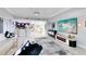 Open living space with modern decor and a view of the dining area at 7593 Gathering Dr # 802, Reunion, FL 34747