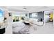 Bright living room with white sectional sofa and large windows at 7593 Gathering Dr # 802, Reunion, FL 34747