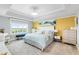 Spacious main bedroom with large window, plush bedding, and stylish furniture at 7593 Gathering Dr # 802, Reunion, FL 34747