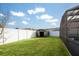 Spacious backyard featuring a storage shed and lush green lawn at 111 Windy Dune Ct, Kissimmee, FL 34743