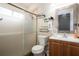 Clean bathroom with a glass shower, wood-look floor, and single vanity at 111 Windy Dune Ct, Kissimmee, FL 34743
