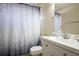 Bathroom boasts a white vanity, decorative shower curtain, and updated fixtures at 111 Windy Dune Ct, Kissimmee, FL 34743