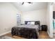 Spacious bedroom with wood-look floors, ceiling fan, and large bed at 111 Windy Dune Ct, Kissimmee, FL 34743