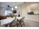 Open-concept dining area adjacent to the living room and kitchen, with views of the pool at 111 Windy Dune Ct, Kissimmee, FL 34743