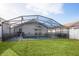 Backyard with screened-in pool and grassy area at 111 Windy Dune Ct, Kissimmee, FL 34743