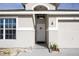 Close-up view of the home's entrance, featuring a charming front door and attached garage at 111 Windy Dune Ct, Kissimmee, FL 34743