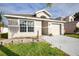 Inviting single-story home exterior with a well-maintained lawn and attached garage at 111 Windy Dune Ct, Kissimmee, FL 34743