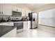 Modern kitchen with white cabinets, stainless steel appliances, and ample counter space at 111 Windy Dune Ct, Kissimmee, FL 34743