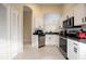 Bright and airy kitchen featuring white cabinets, stainless steel appliances, and a convenient pantry at 111 Windy Dune Ct, Kissimmee, FL 34743