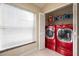Laundry room features red washer and dryer and built-in shelving at 111 Windy Dune Ct, Kissimmee, FL 34743