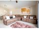 Cozy living area with a plush sectional sofa and a large artwork on the wall at 111 Windy Dune Ct, Kissimmee, FL 34743