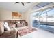 Comfortable living room with a sectional sofa, view of the pool through the sliding door at 111 Windy Dune Ct, Kissimmee, FL 34743