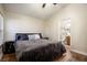 Main bedroom featuring wood-look floors, ceiling fan, and ensuite bathroom access at 111 Windy Dune Ct, Kissimmee, FL 34743