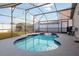 Inviting pool with a screened enclosure, string lights, and a storage shed in the background at 111 Windy Dune Ct, Kissimmee, FL 34743