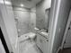 Modern bathroom with white vanity, granite countertop, and marble shower at 1170 S Central Ave, Apopka, FL 32703