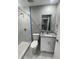 Modern bathroom with white vanity, shower, toilet, and marble floor at 1170 S Central Ave, Apopka, FL 32703