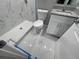 Modern bathroom with white vanity, shower, toilet, and marble floor at 1170 S Central Ave, Apopka, FL 32703
