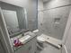 Bathroom with granite countertop vanity, shower, and toilet at 1170 S Central Ave, Apopka, FL 32703