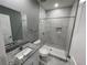 Modern bathroom with white vanity, granite countertop, and marble shower at 1170 S Central Ave, Apopka, FL 32703