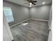 Light-filled bedroom with ceiling fan and floors at 1170 S Central Ave, Apopka, FL 32703