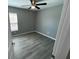 Spacious bedroom with gray walls, vinyl flooring, and ceiling fan at 1170 S Central Ave, Apopka, FL 32703