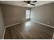 Bright bedroom with grey walls, wood-look floors, and a window with blinds at 1170 S Central Ave, Apopka, FL 32703