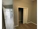 Bedroom with mirrored closet doors and vinyl flooring at 1170 S Central Ave, Apopka, FL 32703