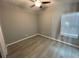 Spacious bedroom with gray walls, vinyl flooring, and ceiling fan at 1170 S Central Ave, Apopka, FL 32703