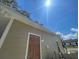 Side view of tan house with brown door and gutters at 1170 S Central Ave, Apopka, FL 32703