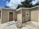 Tan house exterior with brown door and landscaping at 1170 S Central Ave, Apopka, FL 32703