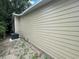 Side view of the house, showcasing its exterior wall and AC unit at 1170 S Central Ave, Apopka, FL 32703