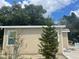 Tan house exterior with landscaping and a tree in the front yard at 1170 S Central Ave, Apopka, FL 32703