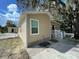 Tan house exterior with white trim, steps, and railing at 1170 S Central Ave, Apopka, FL 32703
