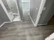 Hallway with wood-look floors and bathroom access at 1170 S Central Ave, Apopka, FL 32703