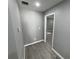 Gray hallway with wood-look floors at 1170 S Central Ave, Apopka, FL 32703